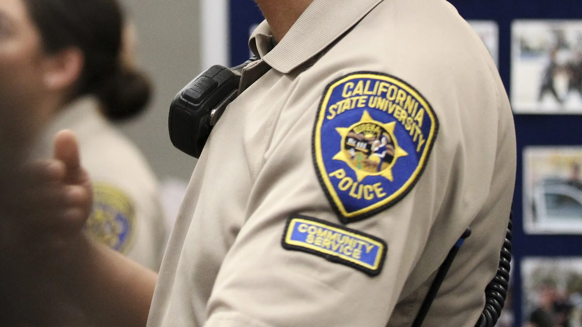 The UPD Community Service Officer patch on a uniform sleeve.